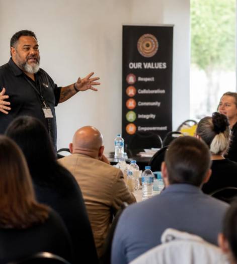 Image of Australian indigenous lecturer delivering training to a large group (1)